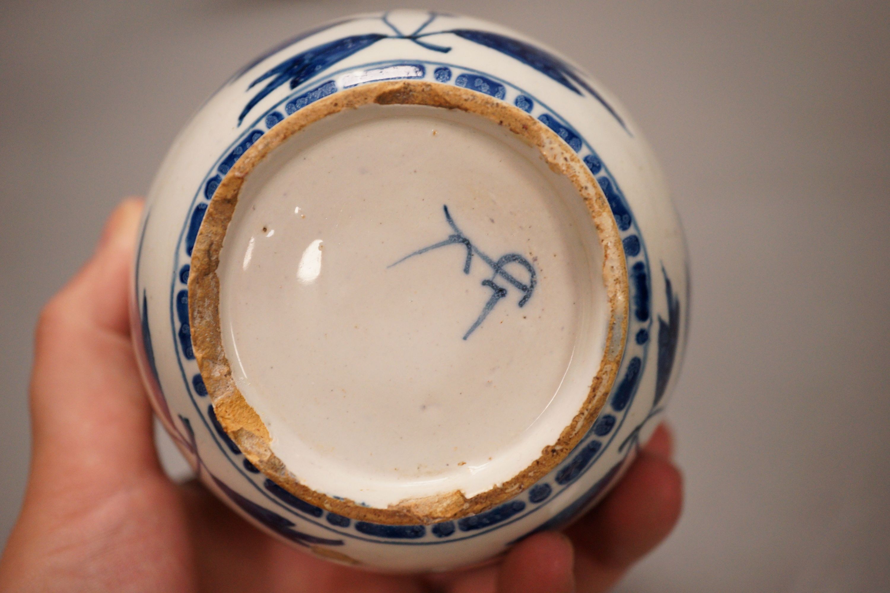 Two 18th century English delftware plates and a 18th century Delft vase, plate diameter 23cm (3)
